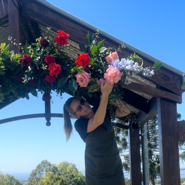 Florist creating wedding arbour florals